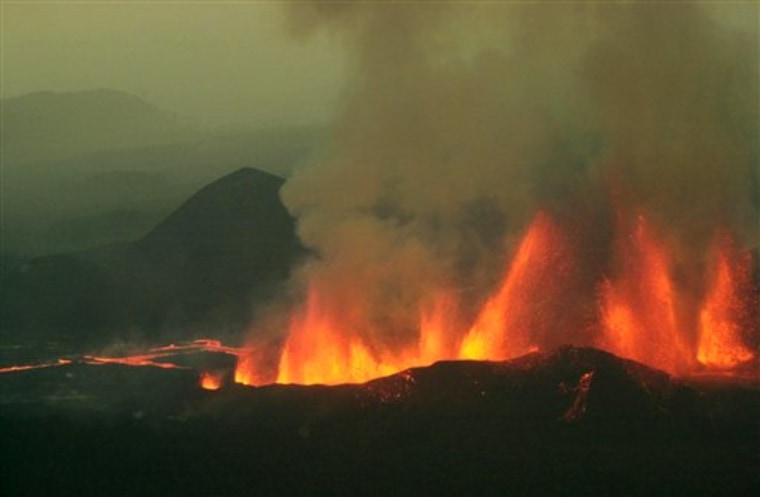 In this Sunday, July 28, 2002 file photo, plumes of lava spew high into the air from Mount Nyamulagira, near the town of Goma in eastern Congo. 